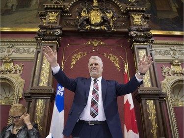 Quebec Premier Philippe Couillard acknowledges caucus members at the National Assembly in Quebec City.