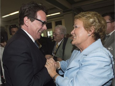 Newly elected leader of the Parti Québécois Pierre Karl Péladeau is greeted by former leader Pauline Marois during a gala dinner on National Patriots' Day in Montreal in 2015.  Both are Université de Montréal alumni.