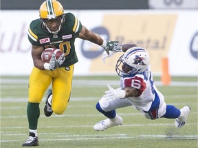 Montreal Alouettes' Raymon Taylor misses the tackle on Edmonton Eskimos' John White during first-half CFL action in Edmonton on Thursday, Aug. 11, 2016.