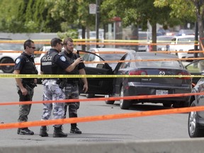 Montreal police at the scene of a shooting on Maurice Lebel St. near Acadie Blvd. in Ahuntsic on Thursday Aug. 18, 2016. A passenger in the Mazda 3 vehicle sustained at least one gunshot wound.