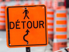 A detour sign amid construction cones in Montreal.