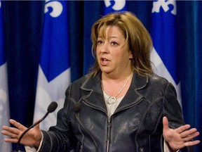FILE - Sylvie Roy, second opposition leader at the legislature, speaks to members of the media before attending question period, at the Quebec legislature in an Oct. 28, 2009, file photo. Roy died Sunday at the age of 51.