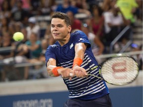 Milos Raonic of Canada hits a return to Dustin Brown of Germany during their 2016 US Open 2016 Men's Singles match at the USTA Billie Jean King National Tennis Center on August 29, 2016 in New York.
