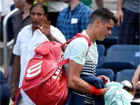 Milos Raonic of Canada walks off court after being defeated by Ryan Harrison of the U.S. in their U.S. Open 2016 men's single match at the USTA Billie Jean King National Tennis Center in New York on August 31, 2016.