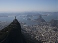 The Christ the Redeemer statue stands in front of the Sugar Loaf mountain and the Guanabara bay in Rio de Janeiro, Brazil, Monday, Aug. 1, 2016. The Summer Games start Aug. 5.