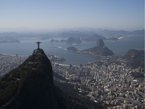 The Christ the Redeemer statue stands in front of the Sugar Loaf mountain and the Guanabara bay in Rio de Janeiro, Brazil, Monday, Aug. 1, 2016. The Summer Games start Aug. 5.