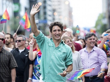 Prime Minister Justin Trudeau waves to the crowd as he attends the annual pride parade in Montreal, Sunday, Aug. 14, 2016.