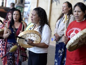 Women drum following the announcement of the inquiry into Murdered and Missing Indigenous Women at the Museum of History in Gatineau, Quebec on Wednesday, Aug. 3, 2016. The federal government has announced the terms of a long-awaited inquiry into murdered and missing indigenous women, unveiling that it will need at least $13.8 million more for the study than was originally expected.