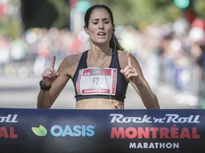 Arianne Raby of Quebec arrives at the finish line at Lafontaine Park to win the Rock 'N' Roll Montreal Marathon with a time of 2:48:55 on Sunday, Sept. 25, 2016.