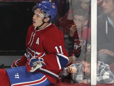 A fan tries to see around Brendan Gallagher at the end of Team Red's bench during a Red vs. White scrimmage with Montreal Canadiens players at the Bell Centre in Montreal Sunday, September 25, 2016.
