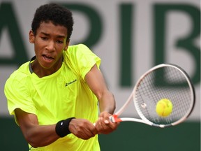 Felix Auger Aliassime of Canada hits a backhand during the Boys Singles final match against Geoffrey Blancaneaux of France on day fifteen of the 2016 French Open at Roland Garros on June 5, 2016 in Paris, France.