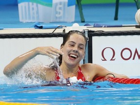 Aurélie Rivard of Canada celebrates winning the gold and silver medals after competing in the Women's 50m Freestyle - S10 Final on day 2 of the Rio 2016 Paralympic Games at the Olympic Aquatics Stadium on Sept. 9, 2016, in Rio de Janeiro.