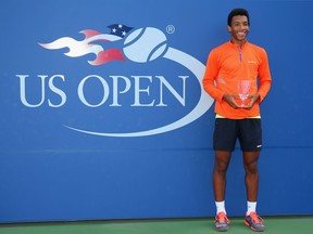 Félix Auger-Aliassime poses with the trophy after defeating Miomir Kecmanovic of Serbia in the Junior Boys' final on Day 14 of the 2016 U.S. Open on Sept. 11, 2016, in New York.