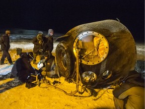 A search and rescue team works on the site of landing of the Soyuz TMA-17M capsule with the International Space Station crew near the town of Dzhezkazgan, Kazakhstan, Friday, Dec. 11, 2015.