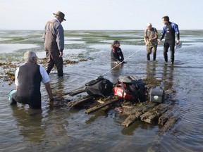 A team of divers and archaeologists work to document the presumed wreck of the Sainte-Anne in a handout photo taken in the Summer of 2015.