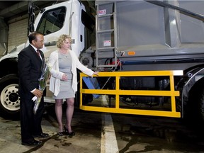 St-Laurent mayor Alan DeSouza and  Jeannette Holman-Price
attend a news look at a truck side guard on Tuesday, May 8, 2012, after the borough announced details of new safety devices on trucks.
