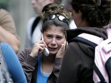 An unidentified woman, believed to be a Dawson College student, cries as she talks on the phone after she ran from the school, Sept. 13, 2006, following the shooting.