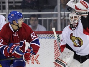 Ottawa Senators' Andreas England and Montreal Canadiens' Matthew Bradley watch Sens' goalie Bryan Pitton try to grab the puck at the 2016 National Hockey League rookie tournament in London, Ont., on Sunday, Sept. 18, 2016.