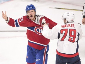 Montreal Canadiens' Andrew Shaw, left, encourages the crowd as he fights with Washington Capitals' Nathan Walker during second period NHL pre-season hockey action Tuesday, September 27, 2016 in Montreal.