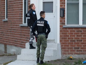 Police go door to door during an investigation of a baby drowning in a bathtub at a home in Lachine. The child is in critical condition.