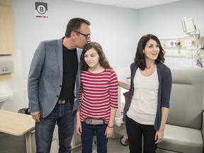 Léa Tremblay-Benoit, centre, and her parents Jean-François Benoit and Karine Tremblay are seen at the allergy and immune tolerance research lab at the MUHC Children's Hospital on Thursday, Sept. 8, 2016.