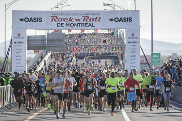 Runners in the second wave of starts begin the Rock 'N' Roll Montreal Marathon over the Jacques-Cartier Bridge on Sunday, September 25, 2016.