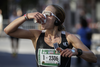 Runner Kayla Segal drinks a cup of water as she takes part in the Rock 'N' Roll Montreal Marathon on Sunday, September 25, 2016.