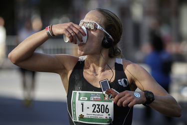 Runner Kayla Segal drinks a cup of water as she takes part in the Rock 'N' Roll Montreal Marathon on Sunday, September 25, 2016.