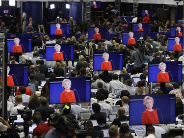 Democratic presidential candidate Hillary Clinton is seen on screens in the media center during the presidential debate between Clinton and Republican presidential candidate Donald Trump at Hofstra University, Monday, Sept. 26, 2016, in Hempstead, N.Y.