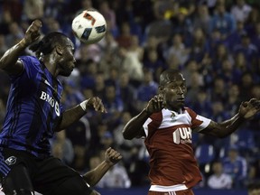 Montreal Impact's Didier Drogba, left, heads the ball as New England Revolution Jose Goncalves during first half MLS soccer action in Montreal, Saturday, September 17, 2016.