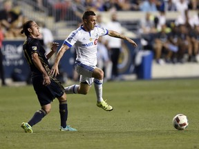 Montreal Impact's Donny Toia (25) steals the ball away from Philadelphia Union's Alejandro Bedoya (11) in the first half of an MLS soccer match on Saturday, Sept. 10, 2016, in Chester, Pa.