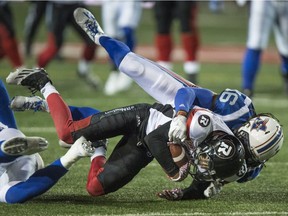 Ottawa Redblacks wide receiver Chris Williams is tackled by Montreal Alouettes defensive back Ethan Davis (16) during first half CFL football action, in Montreal on Thursday, September 1, 2016.