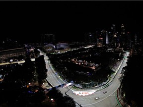 F1 drivers hit the flood-lit Marina Bay street circuit during practice for the Singapore Grand Prix.