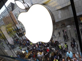 In this Friday, Sept. 25, 2015, file photo, people wait in front of the Apple store in Munich, before the worldwide launch of the iPhone 6s.