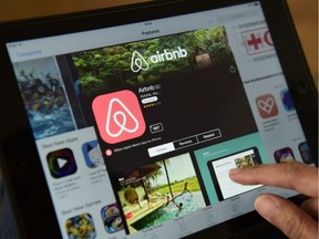 A woman browses the Airbnb website.