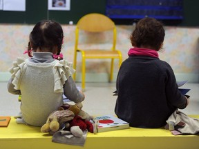 Two-year-olds read books in relative solitude.