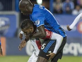 Montreal Impact defender Hassoun Camara, right, holds on to San Jose Earthquakes midfielder Alberto Quintero by the neck during second half MLS action Wednesday, Sept. 28, 2016 in Montreal.
