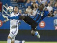 Montreal Impact defender Hassoun Camara kicks the ball away from Orlando City SC defender Luke Boden during first half MLS action Wednesday, September 7, 2016 in Montreal.