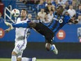 Montreal Impact defender Hassoun Camara kicks the ball away from Orlando City FC defender Luke Boden during first half MLS action Wednesday, September 7, 2016 in Montreal.