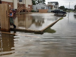 Chloe Riffle, 7, watches as she is surrounded by water on Sunday, Sept. 4, 2016, in the Ocean View section of Norfolk, Va.  Storm system Hermine spun away from the U.S. East Coast on Sunday, removing the threat of heavy rain but maintaining enough power to churn dangerous waves and currents -- and keep beaches off-limits to disappointed swimmers and surfers during the holiday weekend.