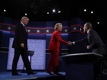 Democratic presidential nominee Hillary Clinton (C) and Republican presidential nominee Donald Trump (L) greet NBC's Lester Holt before the start of the first presidential debate at Hofstra University on September 26, 2016 in Hempstead, New York.