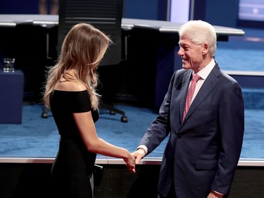 Republican presidential nominee Donald Trump's wife, Melania Trump greets with Democratic presidential nominee Hillary Clinton's husband and former U.S. President Bill Clinton during the Presidential Debate at Hofstra University on September 26, 2016 in Hempstead, New York.