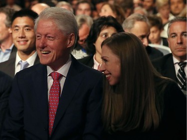 Former U.S. president Bill Clinton (L) and his daughter Chelsea Clinton (R) look on before the start of the first presidential debate with Democratic presidential nominee Hillary Clinton and Republican presidential nominee Donald Trump at Hofstra University on September 26, 2016 in Hempstead, New York.