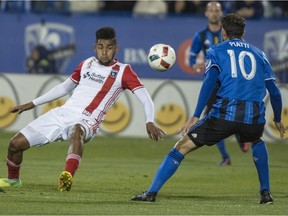 San Jose Earthquakes forward Henok Goitom slips after kicking the ball in front of Montreal Impact midfielder Ignacio Piatti during first half MLS action Wednesday, September 28, 2016 in Montreal.