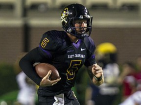 East Carolina quarterback Shane Carden scrambles for yardage against Florida Atlantic during the second half of an NCAA college football game Thursday, Sept. 5, 2013, in Greenville, N.C.