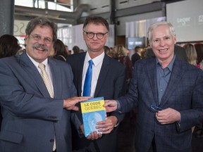 Authors Jacques Nantel, left to right, Jean-Marc Léger and Pierre Duhamel hold a copy of their book Le Code Québec at the book's launch party in Montreal on Monday, September 26, 2016.