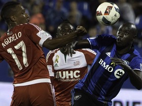 New England Revolution's Juan Agudelo (17) and Montreal Impact's Hassoun Camara battle for the ball during first half MLS soccer action in Montreal, Saturday, September 17, 2016.