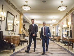 Prime Minister Justin Trudeau, left, and London Mayor Sadiq Khan walk down the hall of the Ritz hotel at the Global Progress conference Thursday.