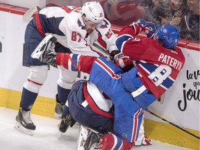 Washington Capitals' Liam O'Brien, left, and Garret Mitchell collide with Montreal Canadiens' Greg Pateryn during first period NHL pre-season hockey action Tuesday, September 27, 2016 in Montreal.