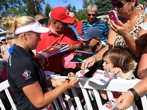 Brooke Henderson of Canada signs autographs for fans following the third round of the Manulife LPGA Classic at Whistle Bear Golf Club on Sept. 3, 2016, in Cambridge, Ont..